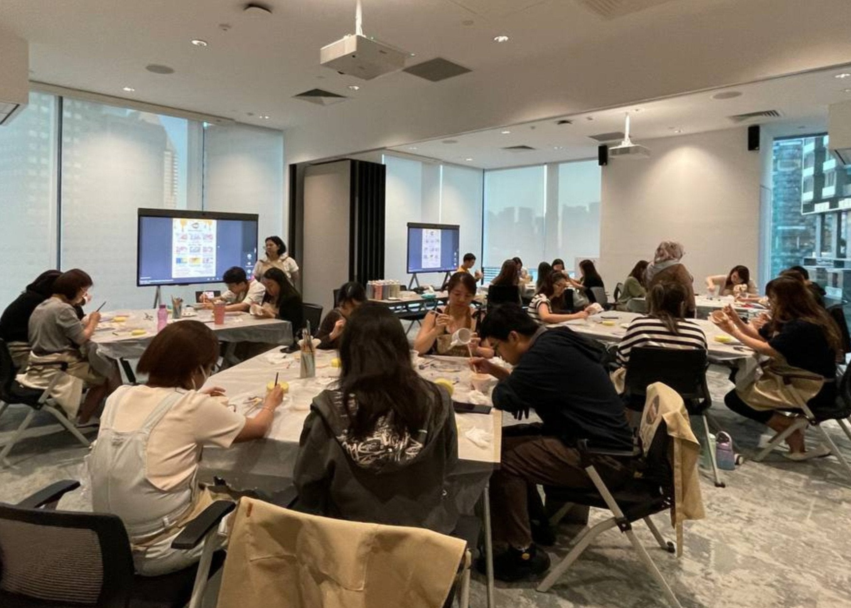 Group enjoying an off-site pottery painting session hosted by PotteryPlease at their chosen venue, perfect for team-building, celebrations, and creative bonding. Located in Singapore